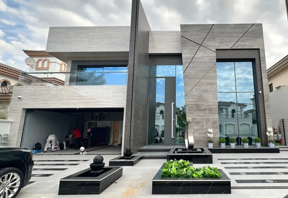 Contemporary villa facade with minimal-framed aluminium glazing across two storeys